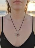 Silver sun with carnelian stone