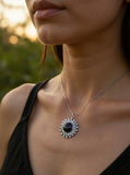 Silver sun pendant with black sandstone